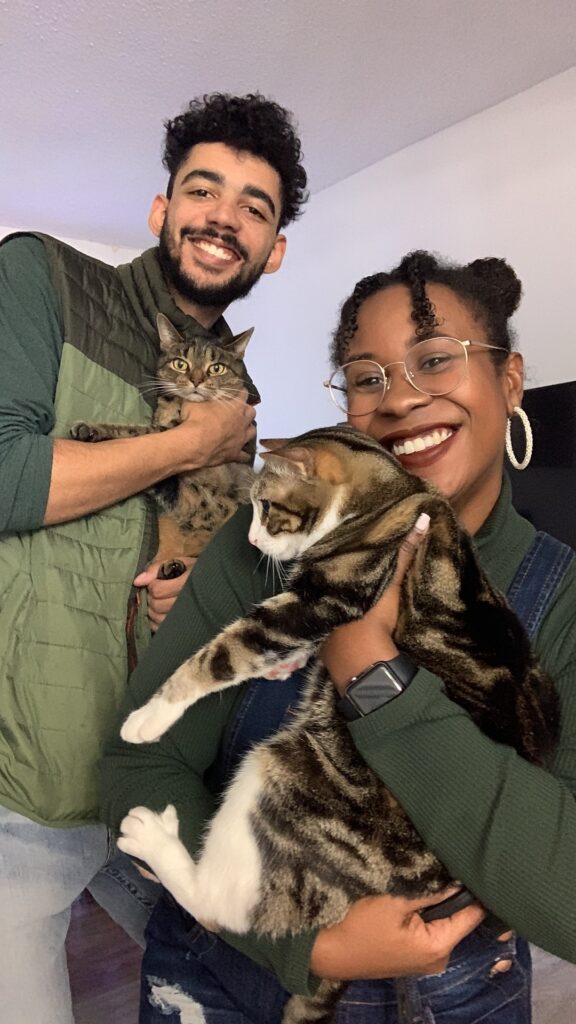Kayela and her fiance holding their cats