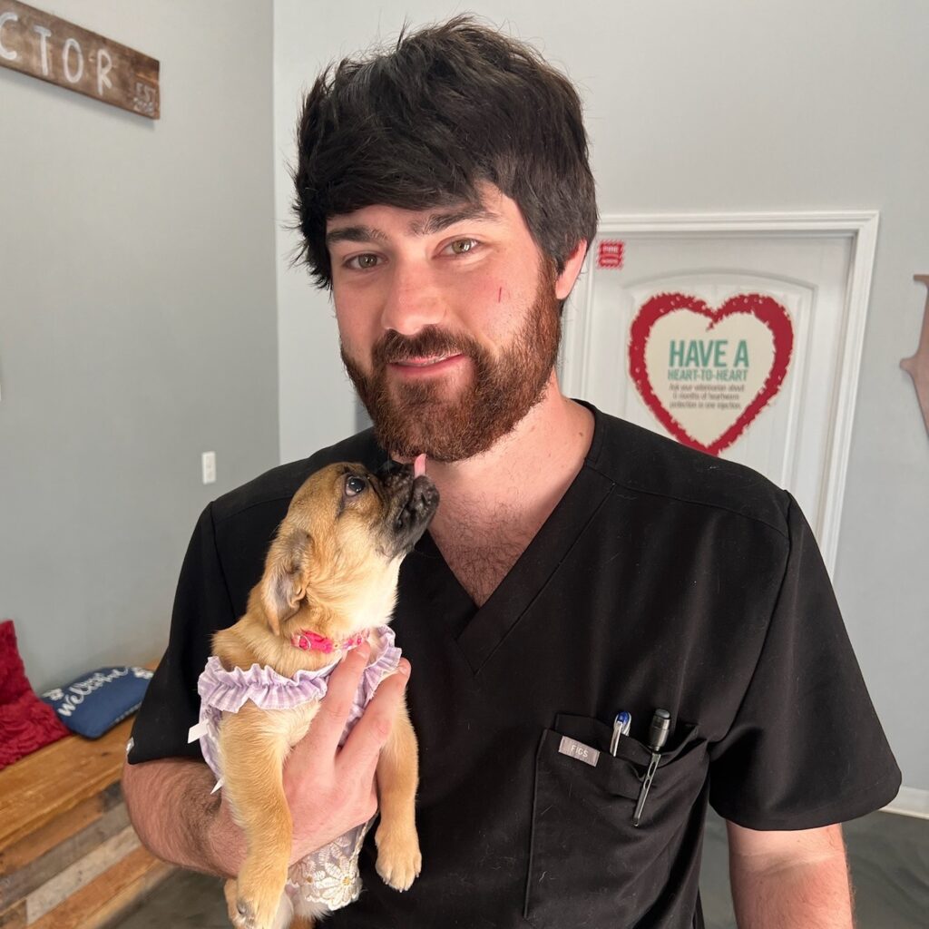 Conner Boley holding a small dog