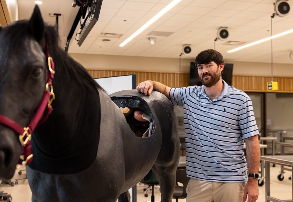 Conner Boley with a life-size horse model