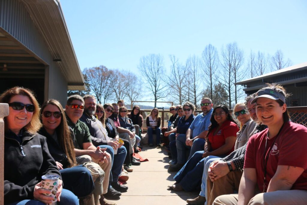 a group of adults sitting on a wagon for a tour