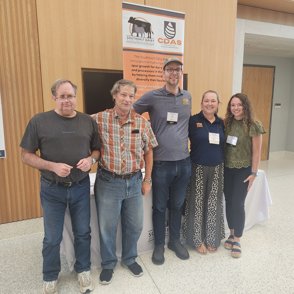 Liz Eckelkamp and four other researchers in front of a Southeast Dairy Business Innovation Initiative display