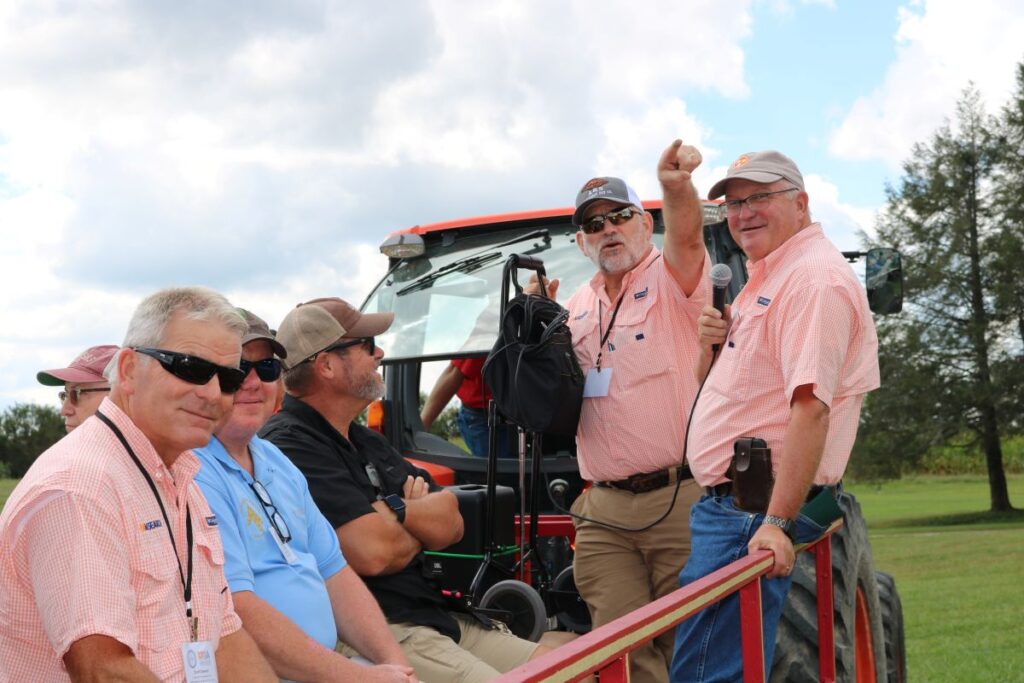 Walt Hitch and four other people on a trailer pulled by a tractor for a Center tour