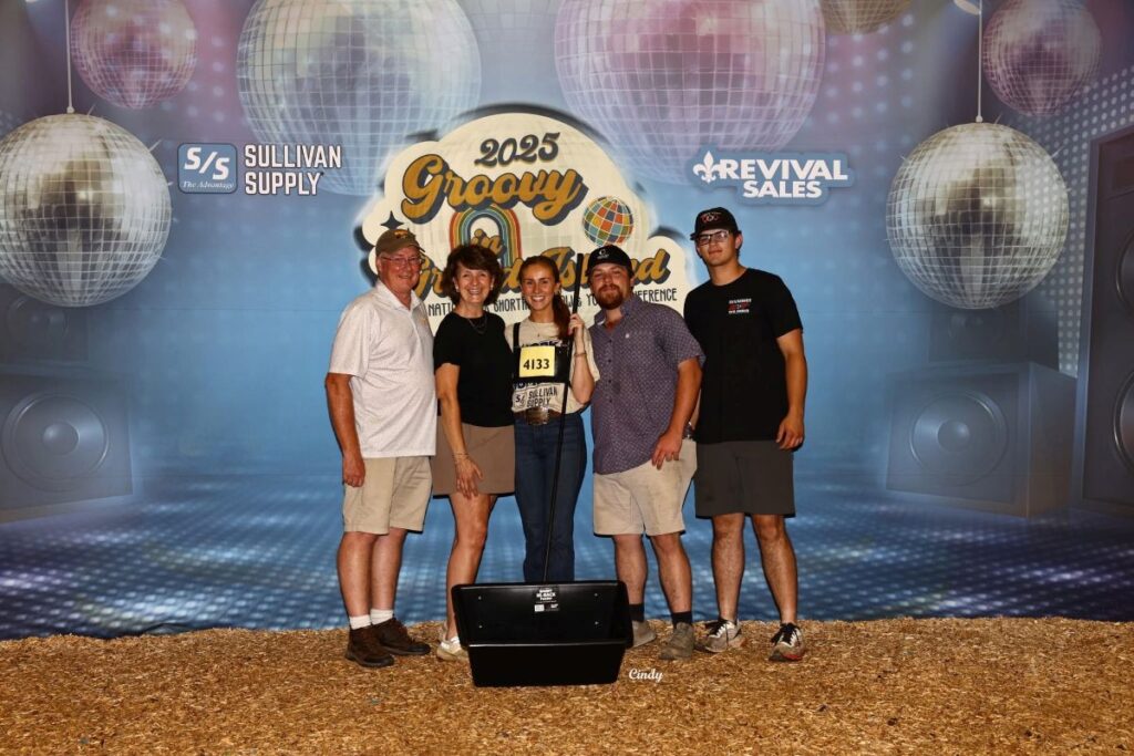 Haylee Ferguson and 4 others in front of a conference sign