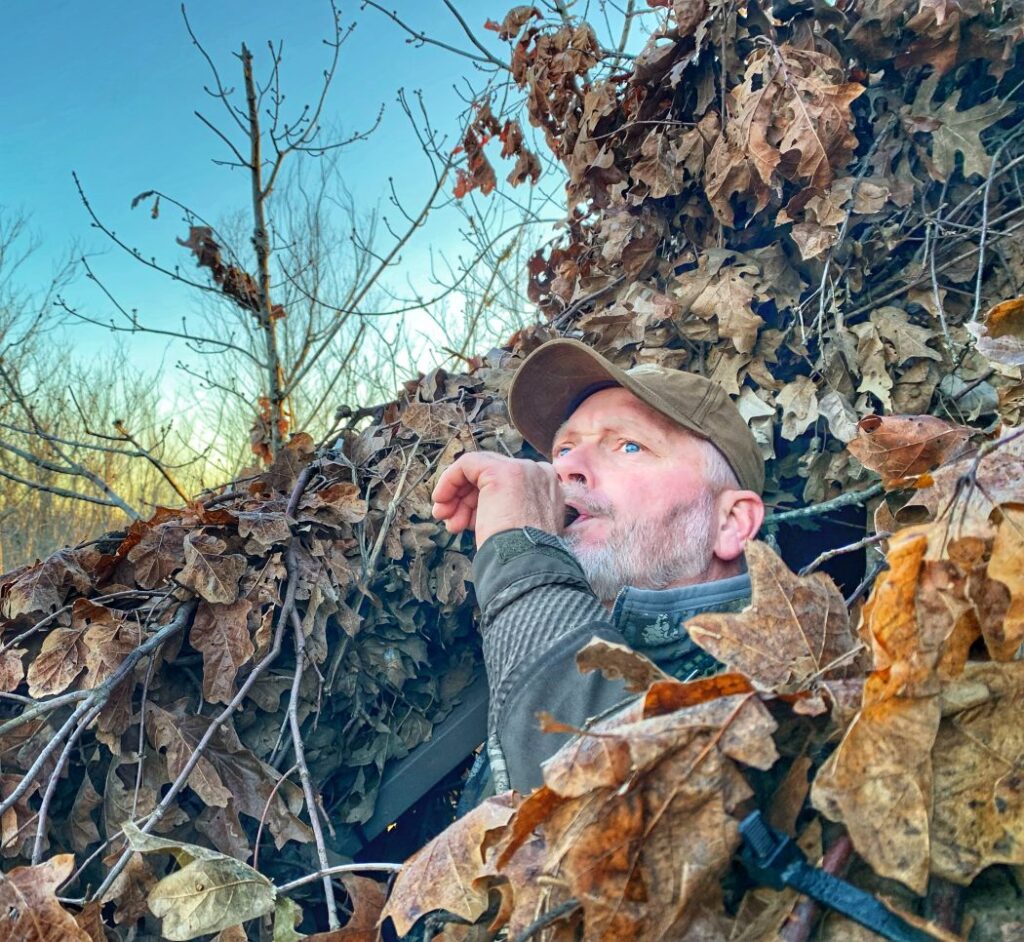 Jason Maxedon using a duck call in a duck blind