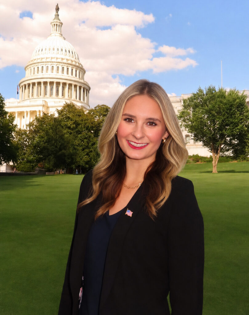 Skylar Baird standing outdoors in front of the United States Capitol building.