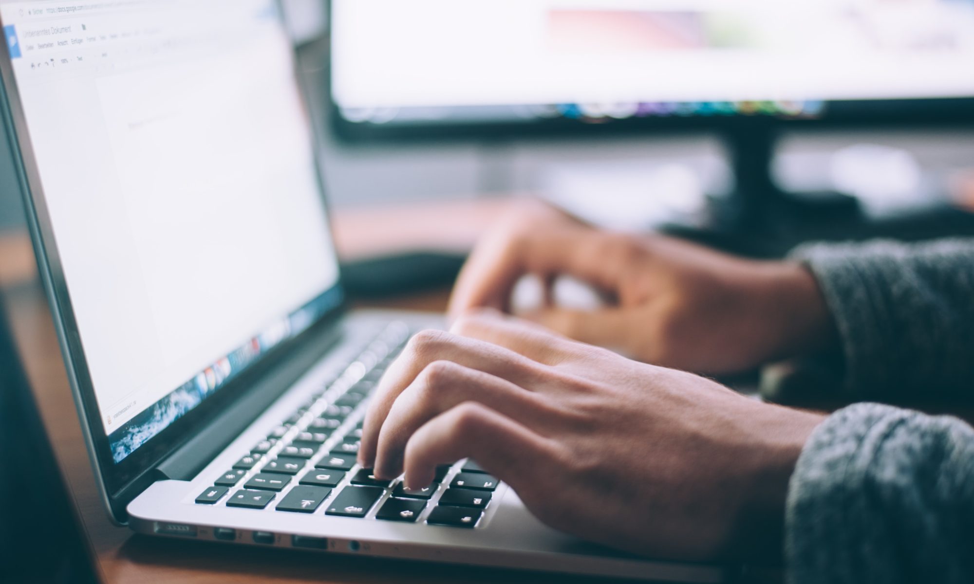 Picture of person typing on a laptop