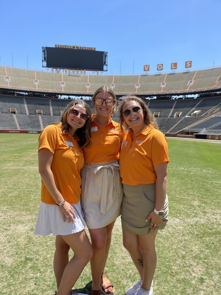 Carragan with two follow ambassadors on the field at Neyland Stadium