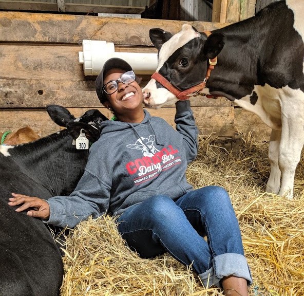 Kayela wearing a Cornell dairy shirt with cows