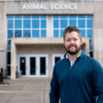 Phil Myer standing in front of the Animal Science building