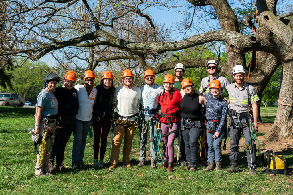 Sharon with her students wearing climbing gear