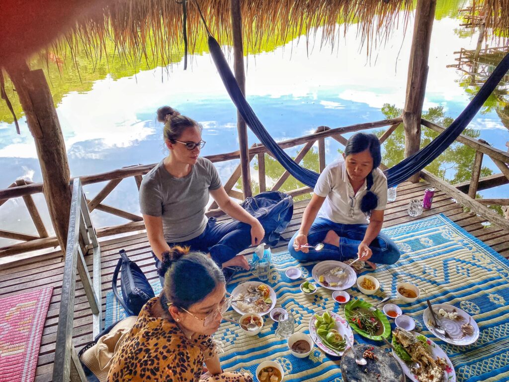 Kristen Johnson sitting with two others to do a hand-on activity on food and nutrition