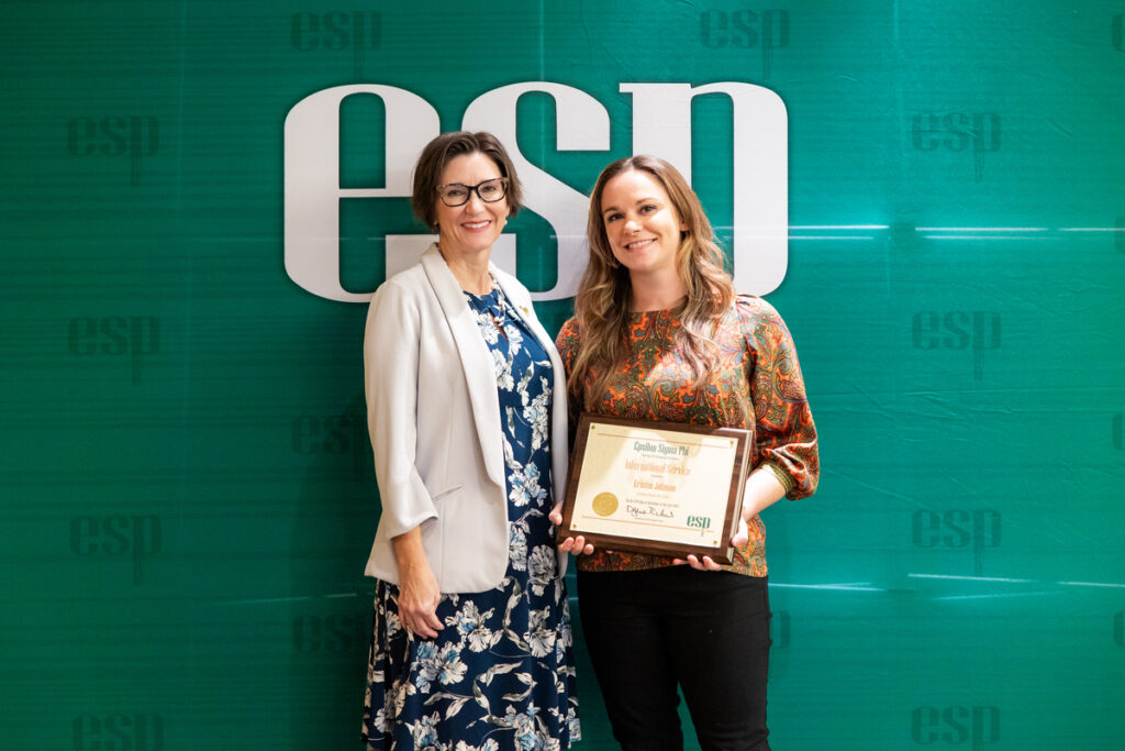 Kristen holding an award from Epsilon Sigma Phi