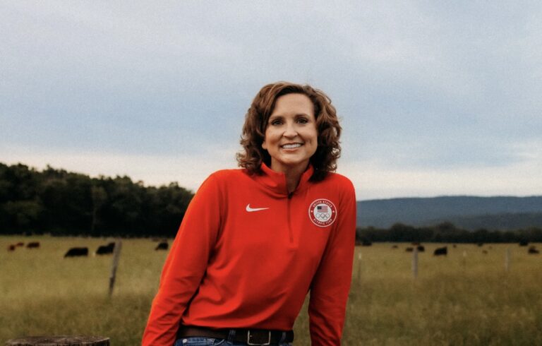 Lydia wearing a Team USA shirt with cattle in the background