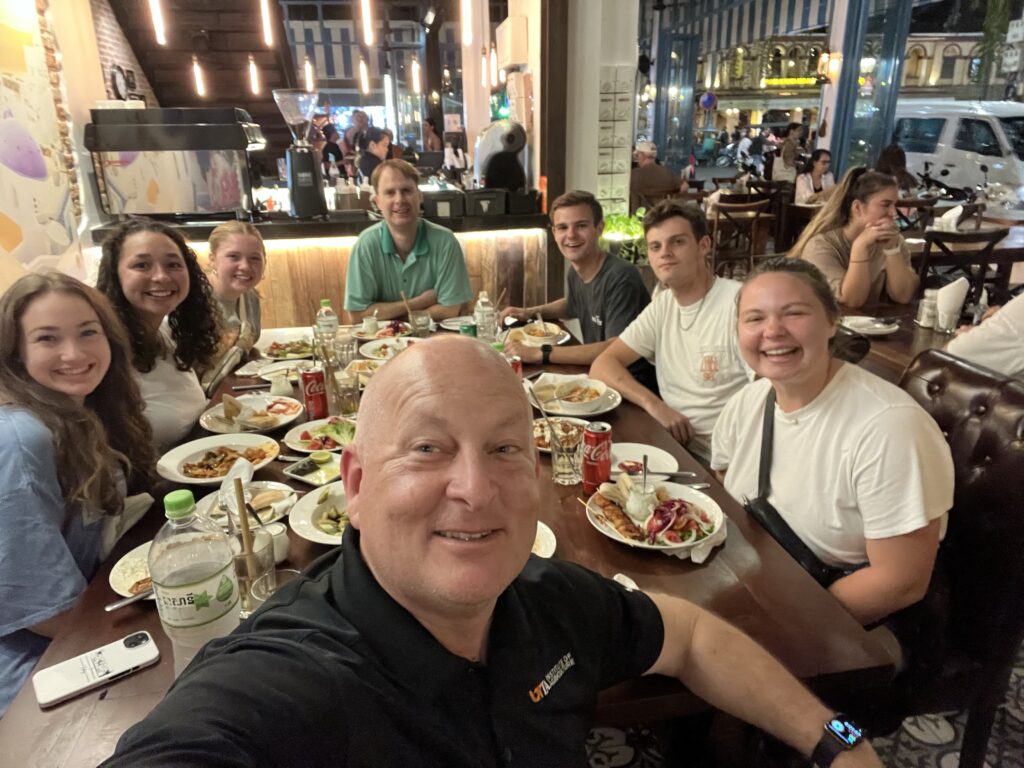 Katie Collins in Cambodia with Tom Gill, Keith Carver and fellow students