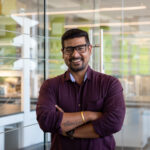 Deb Saha standing in front of a lab