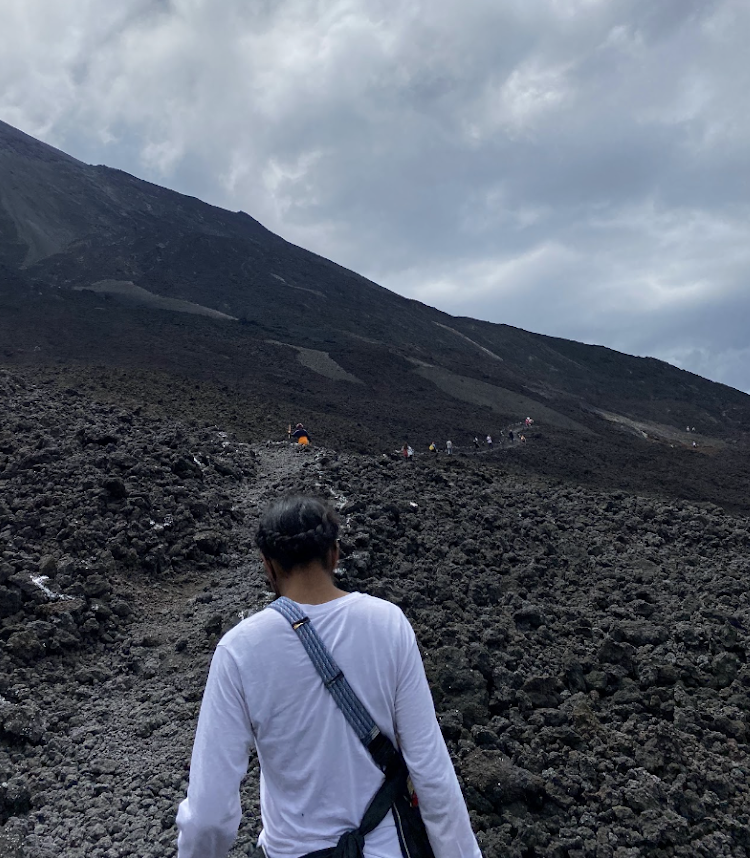 Adrianna walking a rocky trail to the top of a volcano in Guatemala