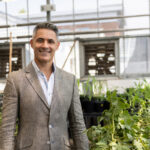 Headshot of Juan Luis Jurat-Fuentes in a greenhouse