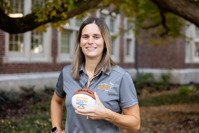 Karen DeLong holding a "Lady Vols" basketball