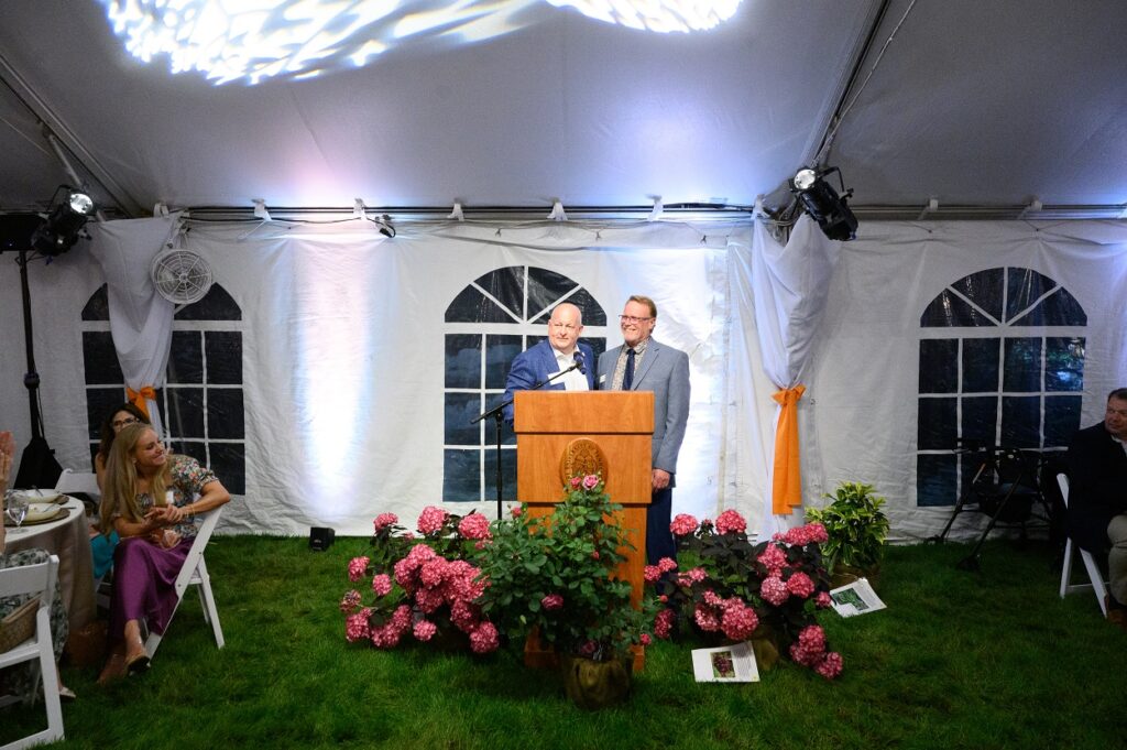 James Newburn and Keith Carver at a podium at the annual Gardens Gala