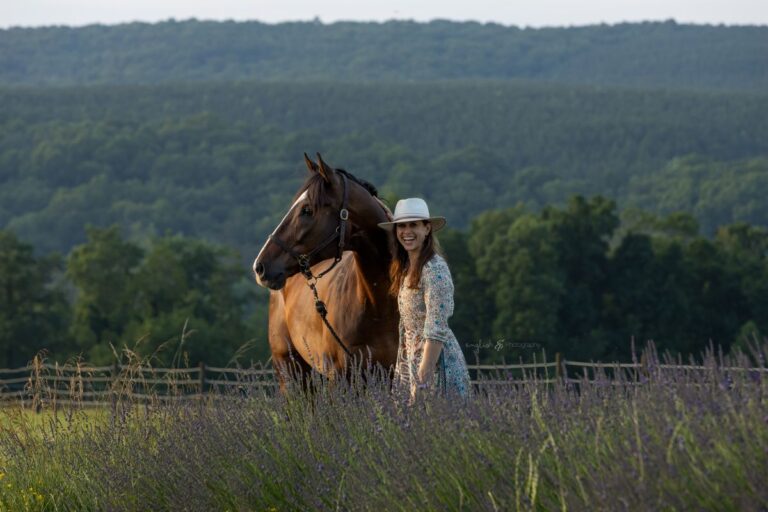 Marisa Shulman in a field with a brown horse