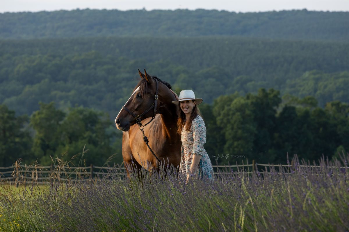 Marisa Shulman in a field with a brown horse