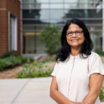 Sindhu Jagadamma in front of the Agriculture and Natural Resources Building