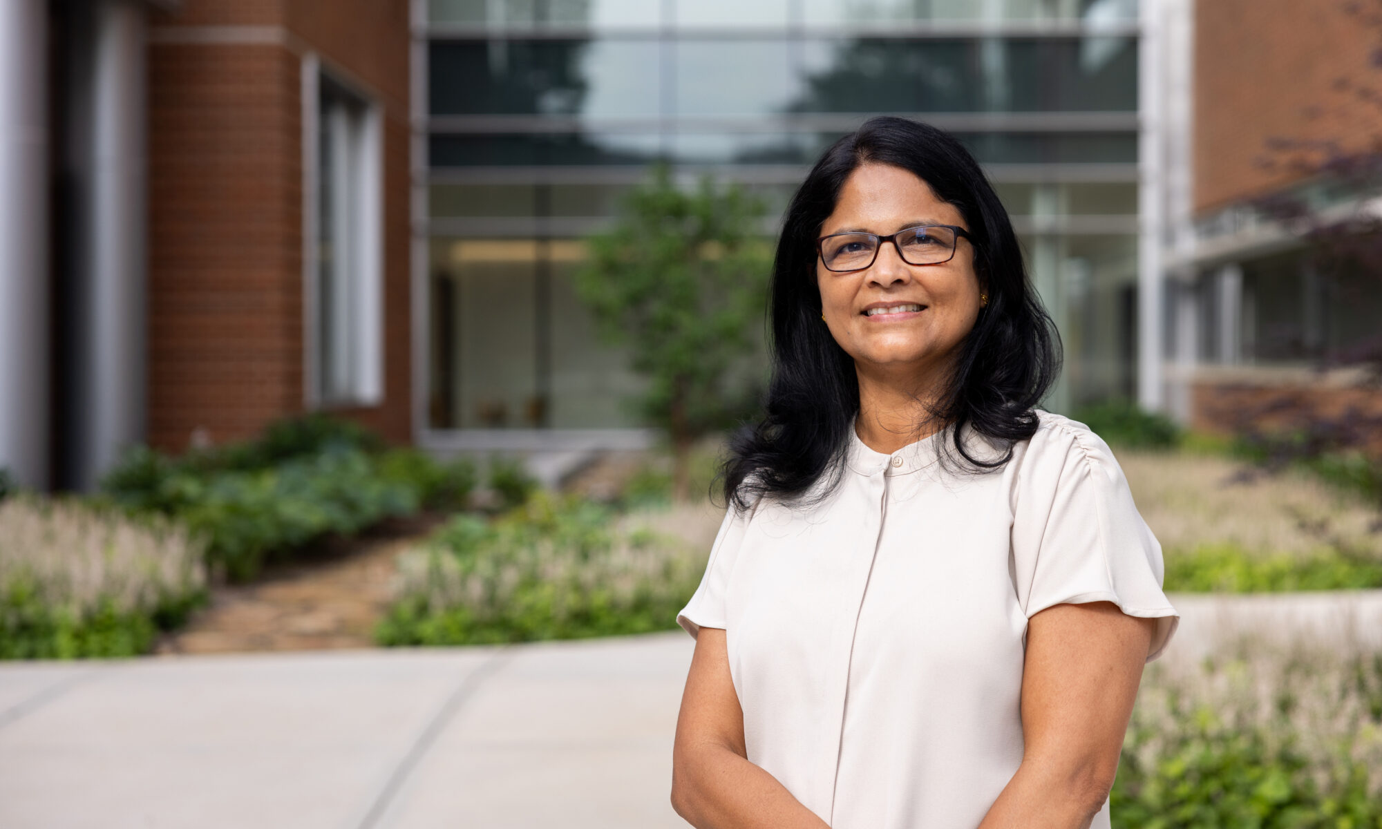 Sindhu Jagadamma in front of the Agriculture and Natural Resources Building