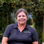 Portrait of Shalena Durkot smiling with greenery in the background.