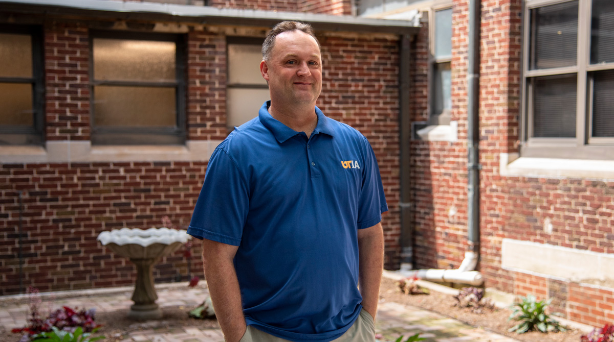 Brian Turner stands in the new Centennial Garden located behind Morgan Hall