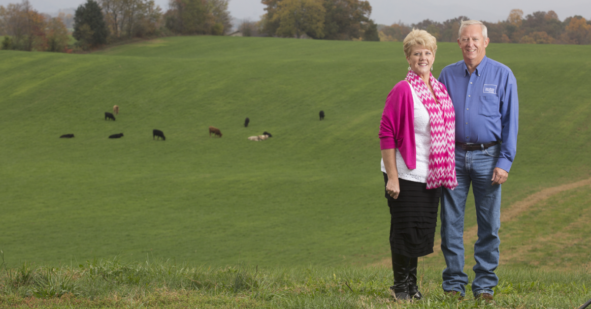 Jeff and Carol Aiken in a field with cattle