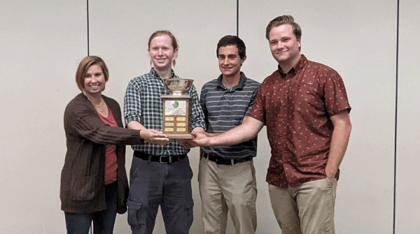 Students in the Society of American Foresters/Forestry Club holding a trophy