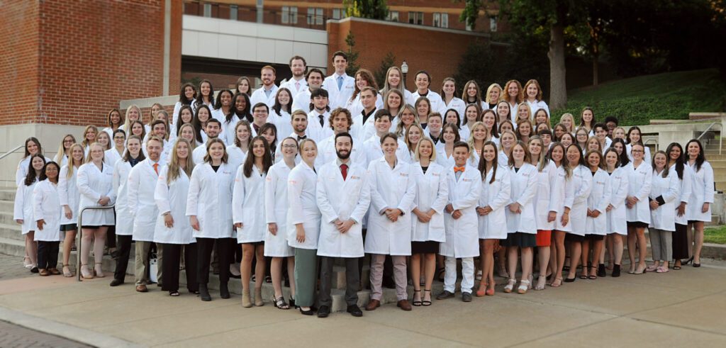 Class of 2027 wearing their white coats