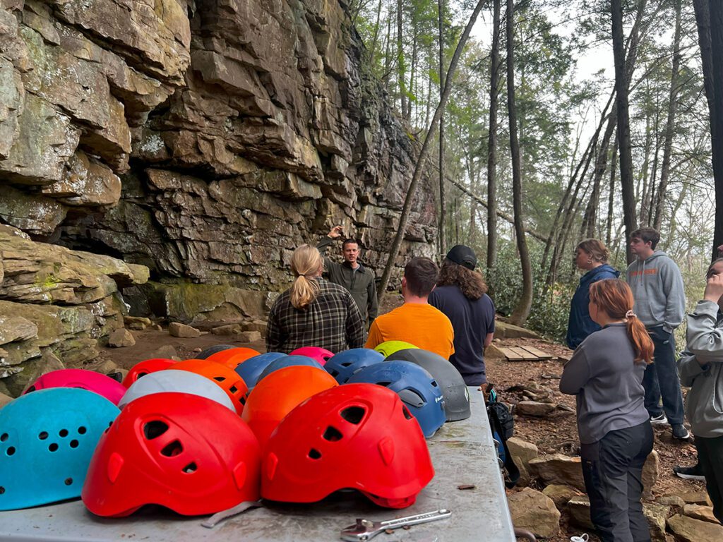 Students in the outdoors rock climbing