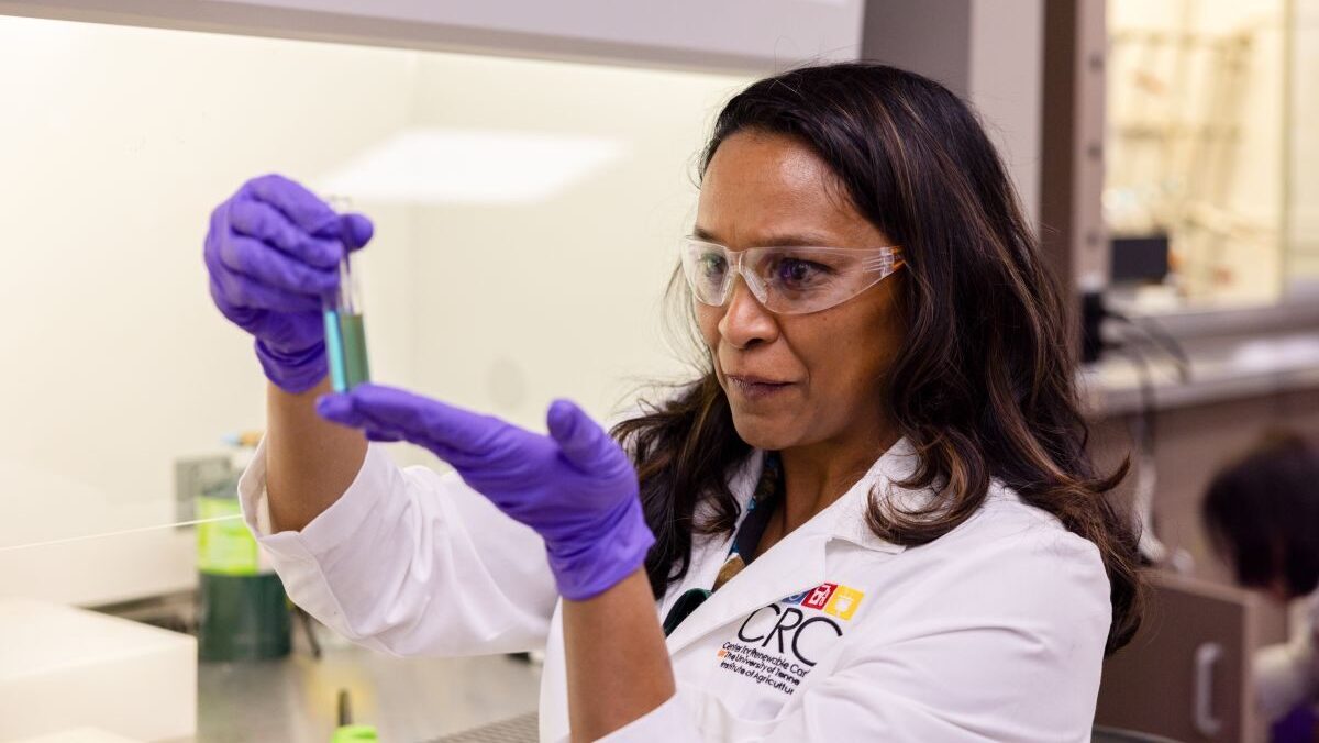 Nicole Labbe holding a test tube in a lab