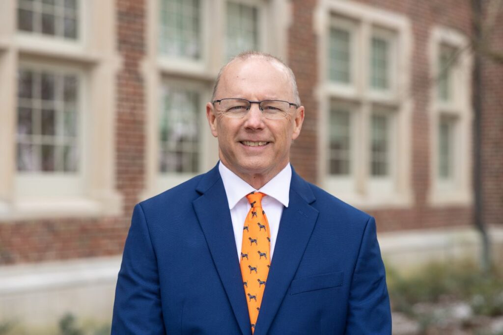 Shawn Hawkins in a suit in front of Morgan Hall