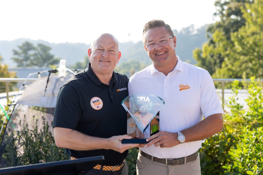 Keith Carver, Sr. Vice President and Sr. Vice Chancellor for UTIA, awards Kent Kilpatrick, owner of the Apple Barn, the Meritorious Service Award, recognizing a half-century of shared growth and commitment to community during Ag Day 2025 in Knoxville